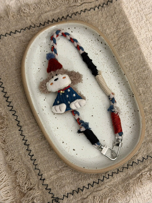 Handmade curly puppy charm with braided strap
