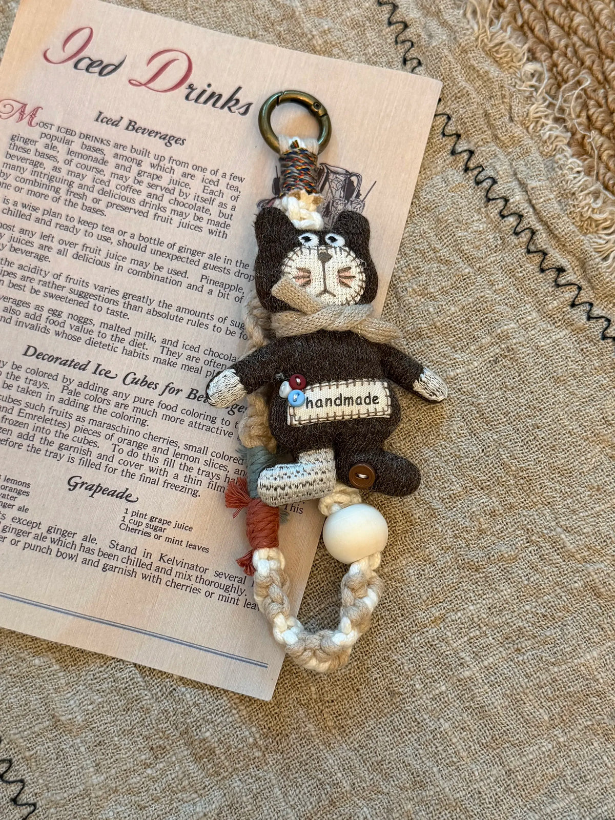 Handmade button cat charm with braided strap