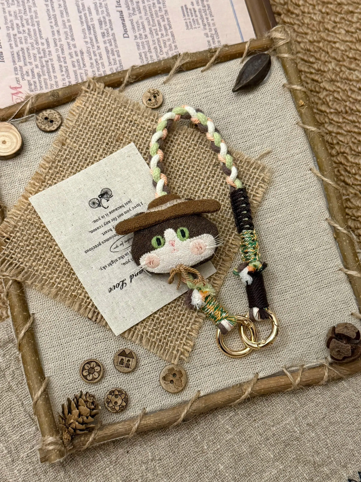 Nomad cat wristlet styled as a bag charm